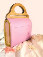 A handmade bag with natural leather, an oak handle, and epoxy resin inserts with
